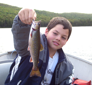 Boy with fish on lake